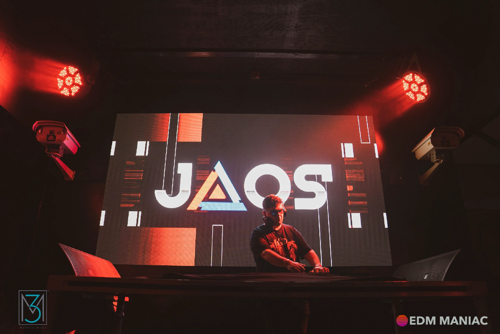 Jose Ortega performing as JAOS under red stage light